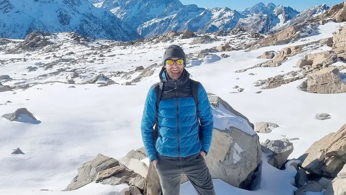 Jan Rehaag standing on a snowy volcanic mountainside in New Zealand